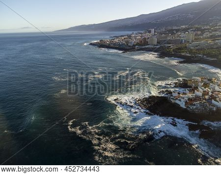 Aerial View On Colorful Houses And Black Lava Rocks In Small Village Punta Brava Near Puerto De La C