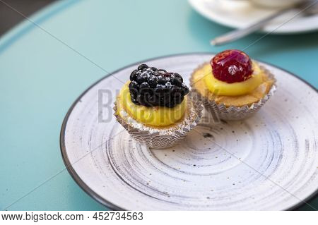 Mini Fruit Italian Cupcakes With Fresh Berries On Board
