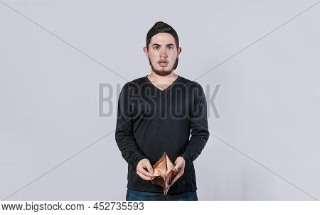 Unhappy And Surprised Man Looking In An Empty Wallet, Man Seeing His Empty Wallet, Young Man With Wa