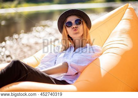 Photo Of Happy Positive Attractive Woman Make Air Kiss Send Outdoors Outside. Portrait Of Young Woma