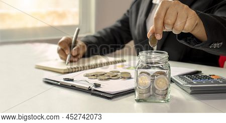 Working Men Aged 25-60, Put Coins In A Glass Jar To Save Money. Retirement Financial Planning Ideas 