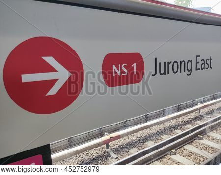 Singapore- Apr 3, 2022:  Red Arrow Shows The Direction Toward Jurong East Statioin At Mrt Platform. 