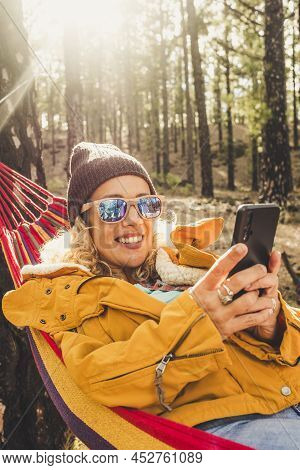 Happy Independent Woman Smile And Do Video Phone Call In Outdoor Nature Park - Roaming And Connected