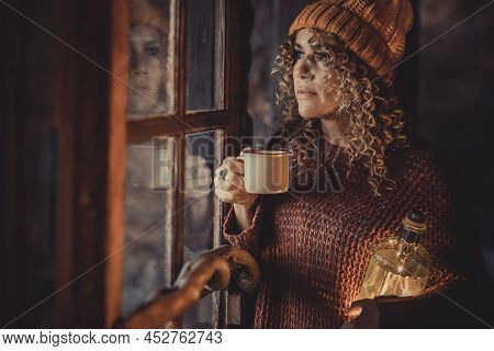 Adult Attractive Woman Portrait Standing At Home And Looking Outside The Windows With Thoughts. Holi