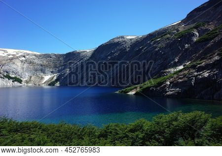 Alpine lake blue water in Patagonia, Laguna Azul in Nahuel Huapi National Park, Surrounded by granite walls of Cerro de las Cristales mountain, Argentina, Nature of South America