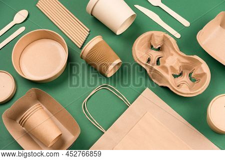 Kraft Paper Utensils On Green Background. Paper Cups And Containers, Wooden Cutlery. Street Food Pap
