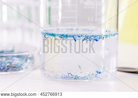 Becker Cup With Polluted Water, Contaminated With Traces Of Plastic And Micro Plastic, Polymer Parti