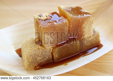 Closeup Of Mouthwatering Warabimochi With Kuromitsu Syrup, A Japanese Traditional Confection
