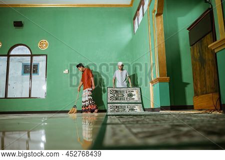 Muslim Young Male Cleaning The Mosque Before Praying