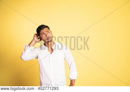 Asian Young Man Confused With Hand Scratching Head Hair