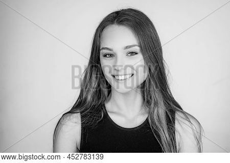 Portrait Of A Cute Blonde Girl Standing On White Background. Close Up Portrait Of Young Cheerful Bea