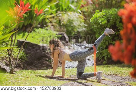 Fitness Woman Doing Stretching Exercise Outdoor In Park. Fit Body On Nature. Athletic Girl Doing Kic