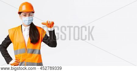 Covid-19 Safety Protocol At Enterpise, Construction And Preventing Virus Concept. Confident Asian Fe