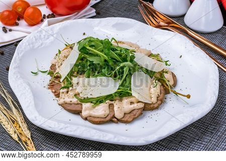 Vitello Tonato From Veal With Tuna Sauce, Parmesan And Aragula On White Plate