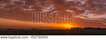 This Beautiful Mountain Mill Is Located In Wannegem-lede Belgium, With The Rise Of The Sun And  Clou