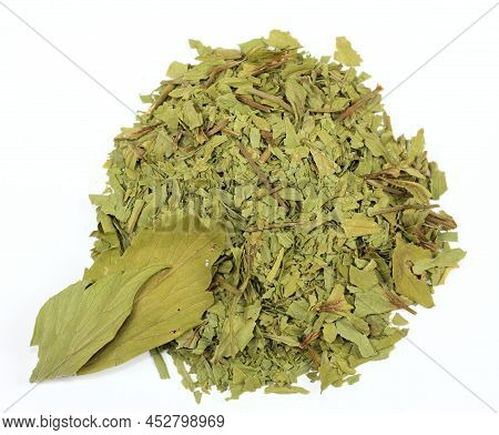 Dried Lovage, Famous Culinary Herb, Lat. Levisticum Officinale. Heap Of Dried Lovage On The White Ba