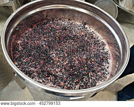 Black Grapes Were Transferred To A Large Metal Vat Where Fermentation And Transformation Into Wine T