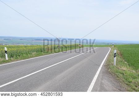 Country Road Across An Eifel Hill In Spring
