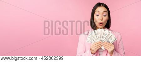Finance, Microcredit And People Concept. Happy Smiling Asian Businesswoman Showing Dollars Money, St