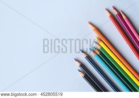 Color Pencils On A Light Gray Blue Background. Top View With Space For Text. Back To School Concept.