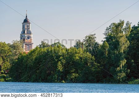 Aluksne Evangelical Lutheran Church Tower Above The Tree Tops, View From The Lake, Latvia