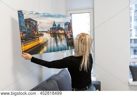 Photo Canvas Print. A Woman Holding A Photography With Gallery Wrap. Photo Printed On Glossy Synthet