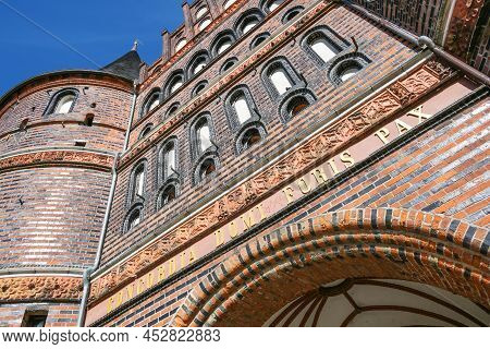 Part Of The Holstentor Or Holsten Gate Of Lubeck In Germany, Medieval Landmark In Red Brick Architec