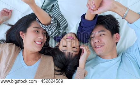 Happy Family Time, Top View Of Asian Young Mother, Father And Children Boy Laying Together On Bed In