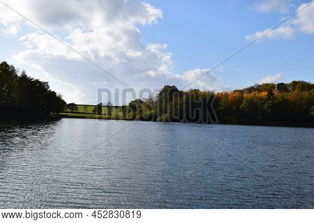 Sunny Autumn Day On Deep Blue Holzmaar In The Eifel