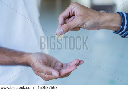 Hand Giving Some Money To Someone At The Mosque