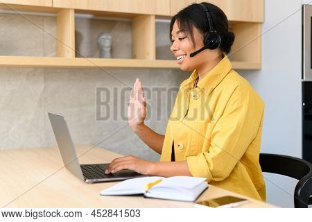 Young Thoughtful African American Female Sudent In A Headset Is Listening To An Online Webinar, Stud