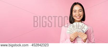 Finance, Microcredit And People Concept. Happy Smiling Asian Businesswoman Showing Dollars Money, St