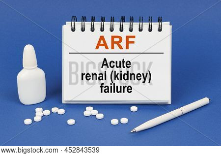 Medical Concept. On A Blue Background, A Pen, Tablets And A Notepad With The Inscription - Arf Acute