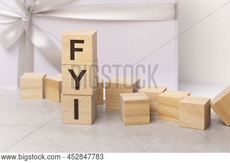 Fyi - Letters On Wooden Cubes. Concept On Light Gift Box Background. Business As Usual Concept Image