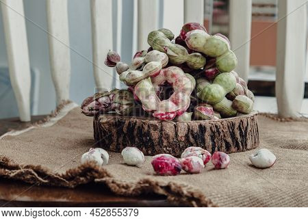 Group Of Manila Tamarind Fruit Or Pithecellobium Dulce Is Another Type Of Thai Herb On Wooden Log Ba