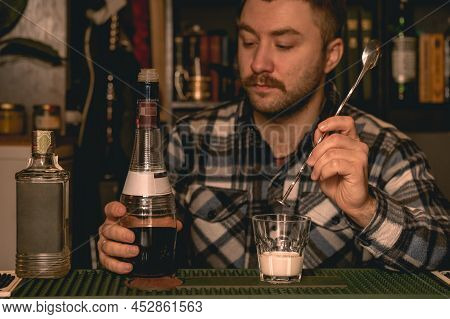 Focused Bartender Preparing Alcoholic Cocktail White Russian Behind Bar Counter