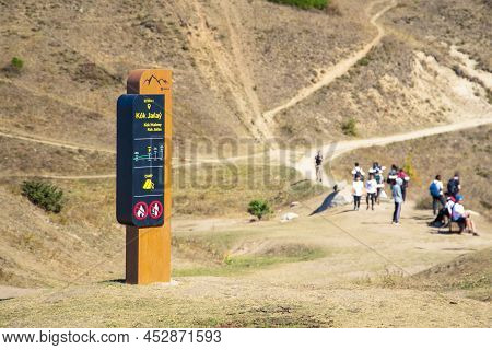 Tourist Information Pole Indicating The Place Of Kok Zhailau And Campsite In Almaty Mountains. Almat