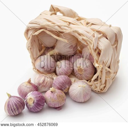 Solo Or Single Clove Garlic In A Basket Over Wite Background