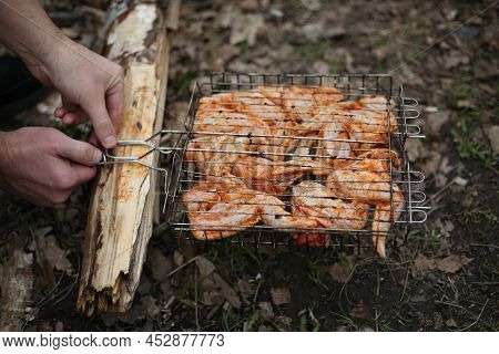 Metal Grill For Barbecue. Shish Kebab In Marinade Is Cooked On The Grill. Fried Chicken Meat With Sp