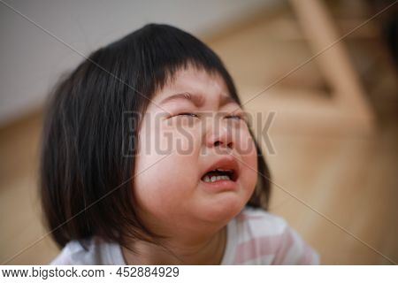 Image Of A Girl Crying At Home