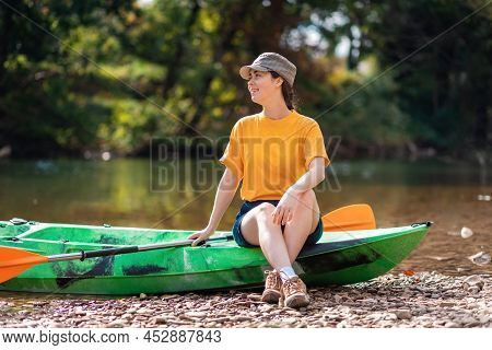 Summer Kayaking. A Beautiful Smiling Woman Sitting On A Kayak. Recretion At The National Park.