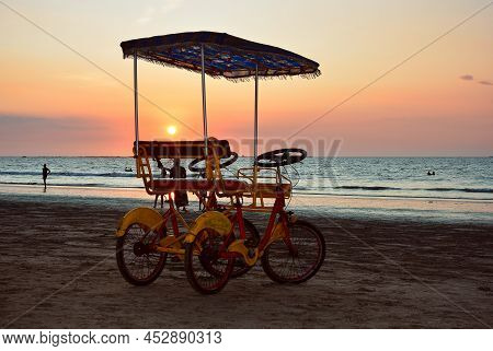 Two Persons Bicycle On Chaung Thar Beach During Sunset, Myanmar