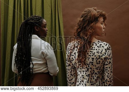 Rear View Of Two Young Diverse Women Standing And Looking In The Same Direction, They Are In Solidar