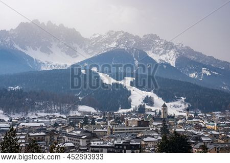 Scenic View Of Beautiful Townscape And Majestic Mountain Range Against Sky