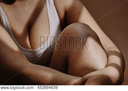 Close-up Of African Plump Girl Sitting In Tank Top