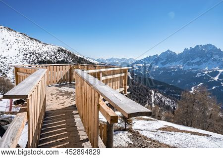 Observation Deck Over Snowcapped Mountains Against Clear Blue Sky