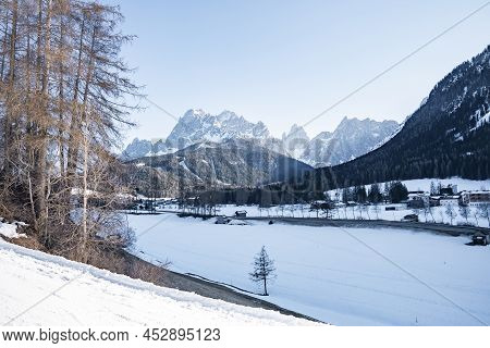 Snow Covered House By Trees On Mountain Against Sky During Winter