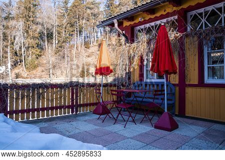 Bench With Table And Chairs In Backyard Of Holiday Home During Winter