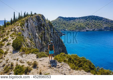Aerial Photo Of Man Traveler On The Cliff Edge Of Beautiful And Picturesque Rocky Coast Close To Ass