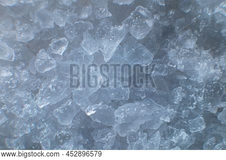 Coarse White Iodized Salt. Detailed Background Texture Macro Close-up. Salt Crystals Of Different Si